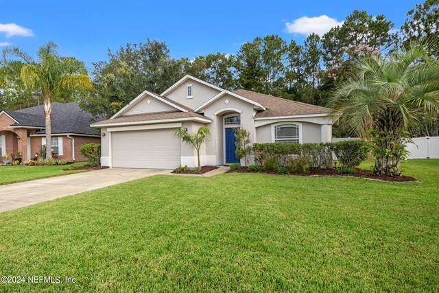 ranch-style house featuring a garage and a front lawn