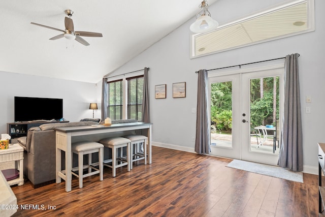 living room featuring dark hardwood / wood-style flooring, lofted ceiling, french doors, and ceiling fan