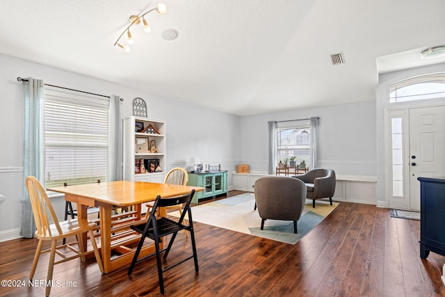 dining area with hardwood / wood-style floors and a textured ceiling