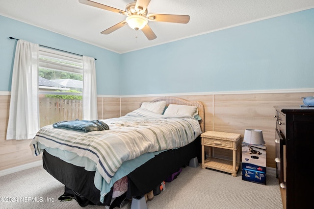 bedroom with ceiling fan and light carpet