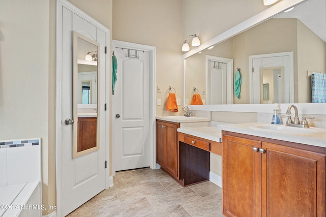 bathroom featuring vanity and a washtub