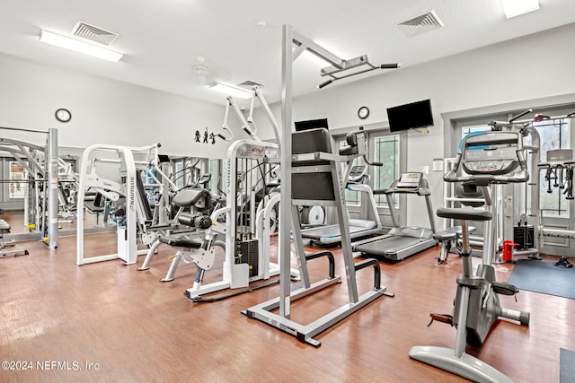 workout area with wood-type flooring