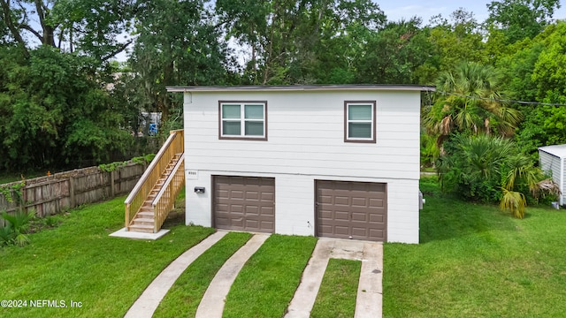 exterior space with a garage and a front lawn