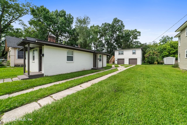 view of home's exterior with a lawn and a shed