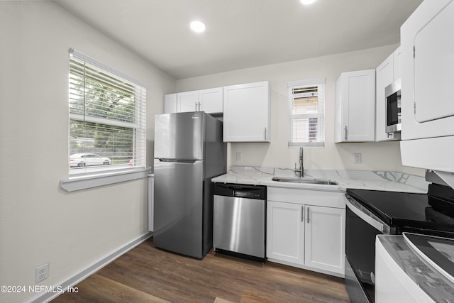 kitchen featuring sink, appliances with stainless steel finishes, dark wood-type flooring, and white cabinetry