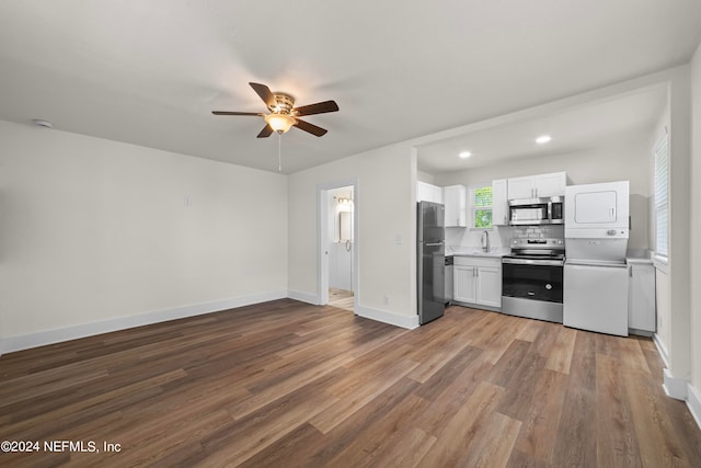 kitchen with hardwood / wood-style flooring, ceiling fan, tasteful backsplash, stainless steel appliances, and white cabinets