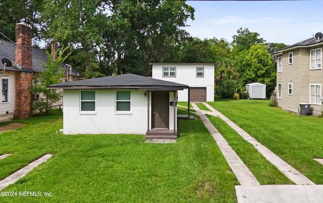 rear view of property featuring a yard and a shed