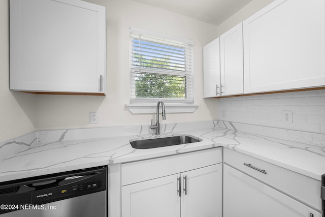 kitchen featuring sink, dishwasher, white cabinets, and light stone counters