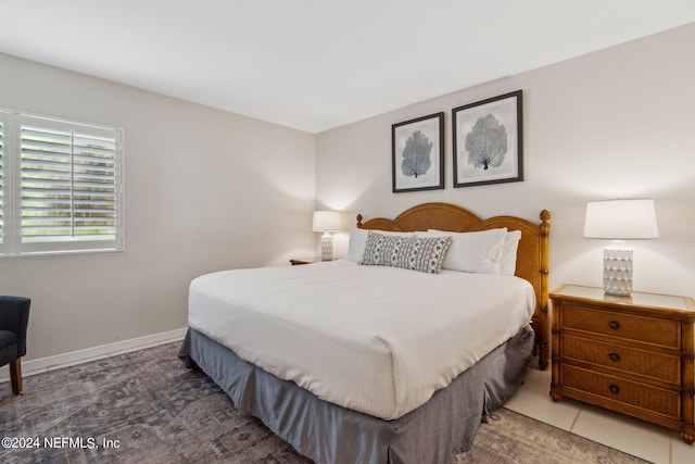 bedroom with dark tile patterned floors