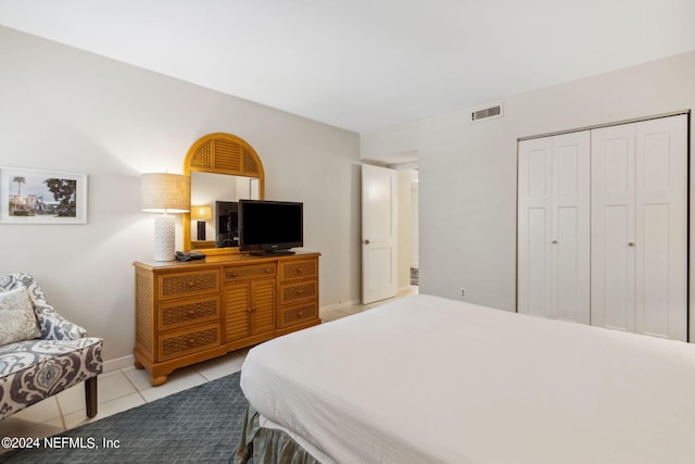 bedroom with light tile patterned flooring and a closet