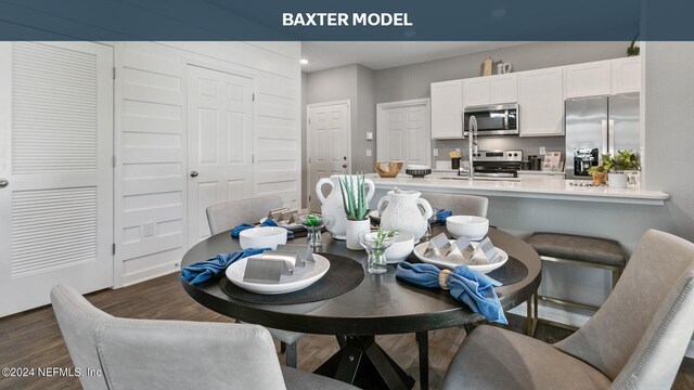 dining space with dark wood-type flooring and sink