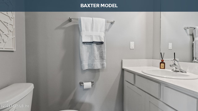 half bath featuring vanity and toilet