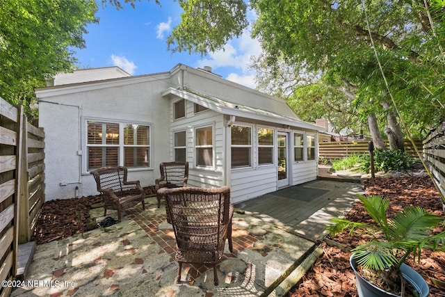 305 Garden Ln, Atlantic Beach, FL 32233 - back of property featuring a patio area, fence, and stucco siding