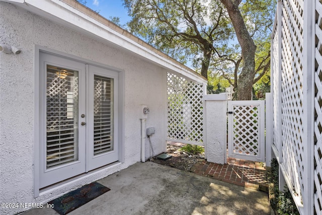 305 Garden Ln, Atlantic Beach, FL 32233 - doorway to property featuring a gate, stucco siding, a patio, and fence