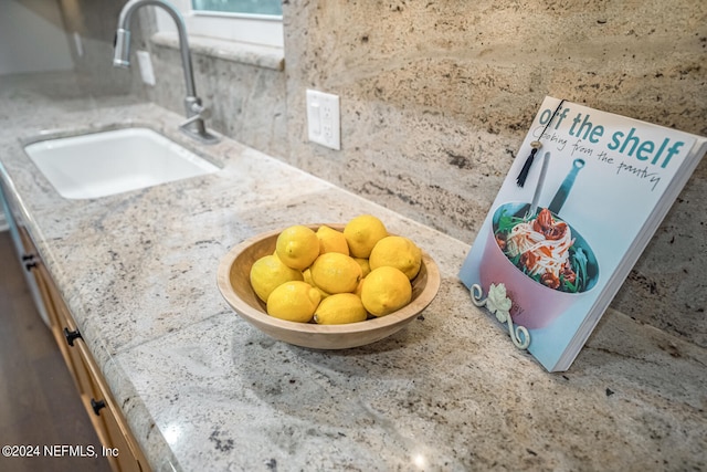 room details featuring light stone counters and sink