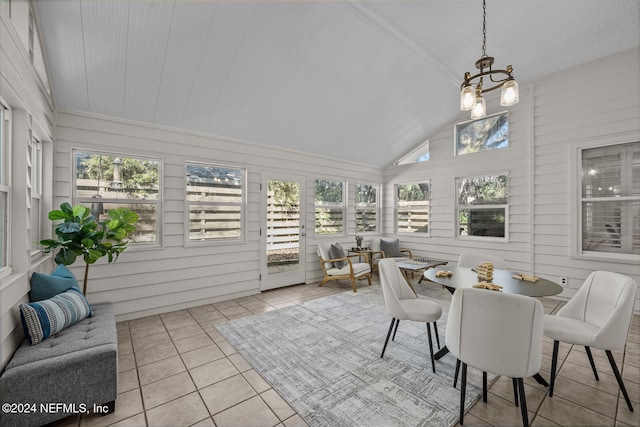 sunroom featuring a chandelier and vaulted ceiling