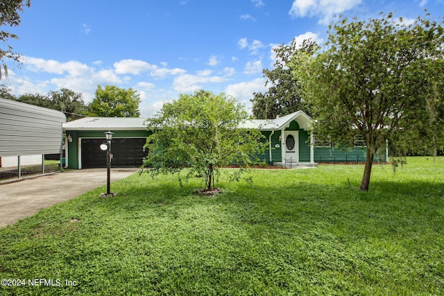 view of front of house featuring a garage, a front yard, metal roof, and driveway