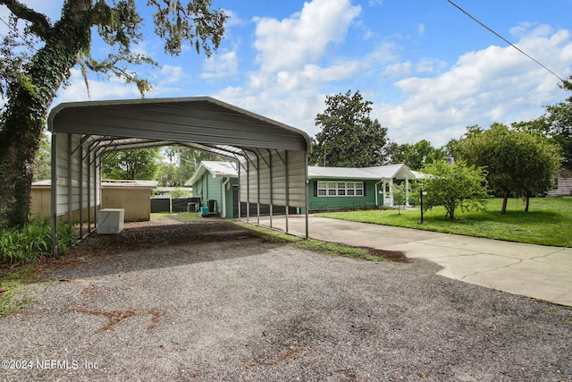 view of parking featuring driveway and a detached carport