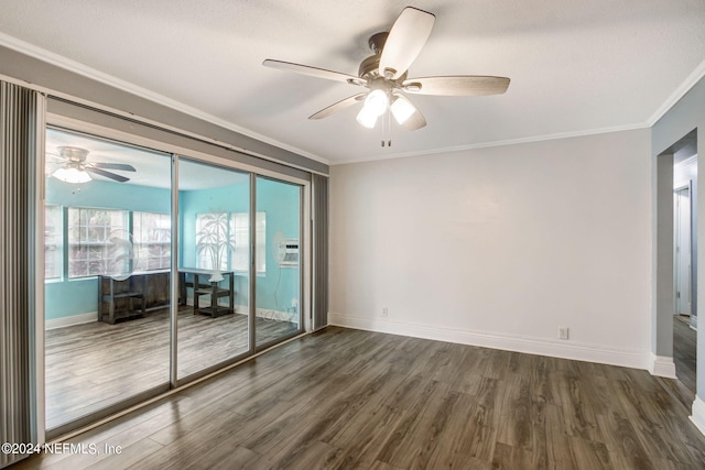 unfurnished room with baseboards, wood finished floors, and crown molding