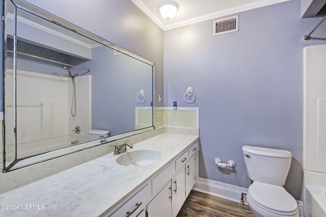 bathroom with toilet, ornamental molding, washtub / shower combination, and visible vents