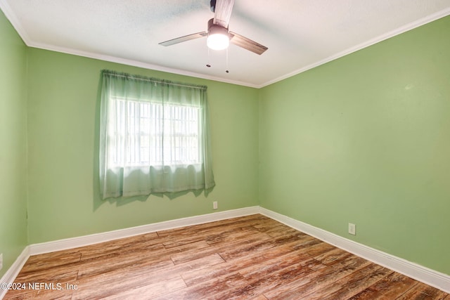 empty room with ceiling fan, baseboards, wood finished floors, and ornamental molding