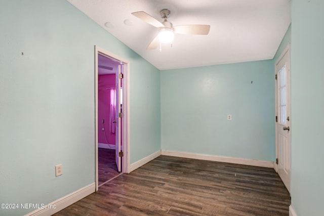 unfurnished room with baseboards, dark wood finished floors, and a ceiling fan