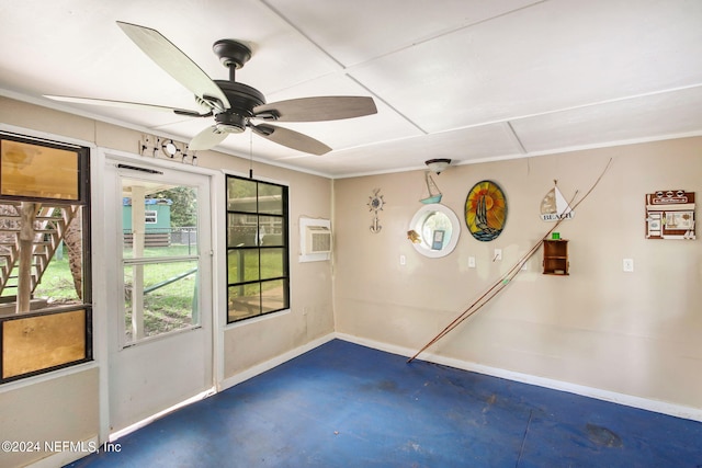 unfurnished room with ceiling fan, concrete floors, a wall unit AC, and baseboards