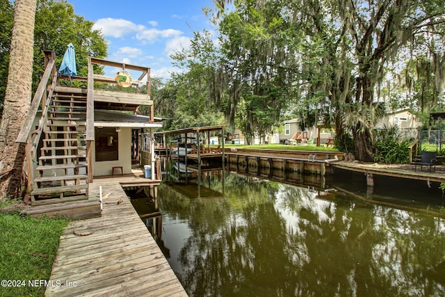 dock area featuring stairway and a water view