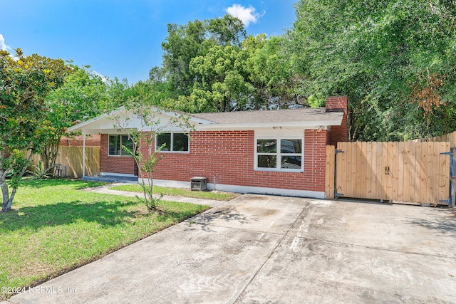 ranch-style house with a front lawn and a patio area