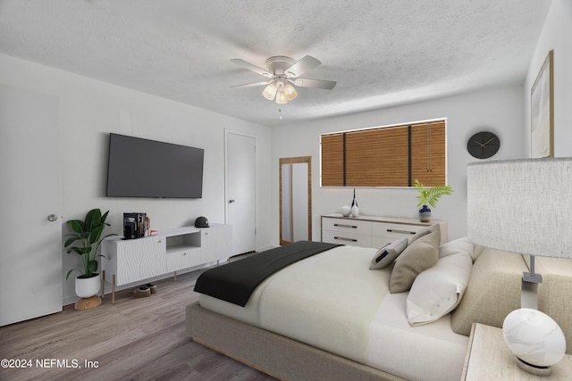 4435 Bedivere Rd, Jacksonville, FL 32208 - bedroom featuring a textured ceiling, ceiling fan, and wood finished floors