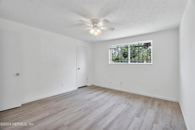 4435 Bedivere Rd, Jacksonville, FL 32208 - spare room featuring a textured ceiling, baseboards, ceiling fan, and wood finished floors