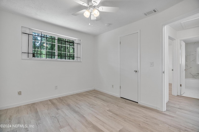 4435 Bedivere Rd, Jacksonville, FL 32208 - unfurnished bedroom featuring attic access, baseboards, a textured ceiling, visible vents, and wood finished floors