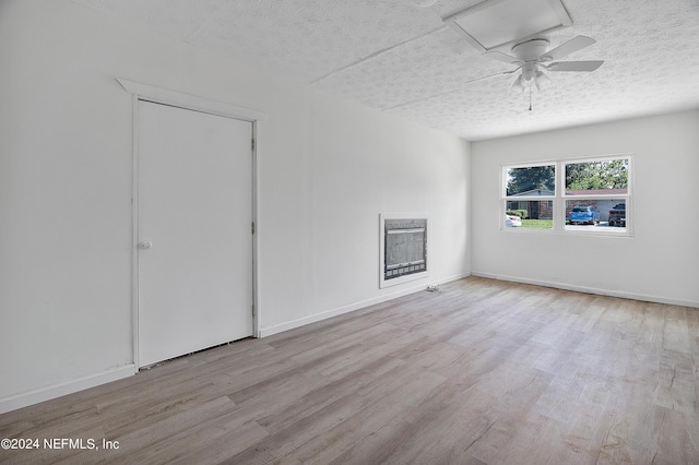 4435 Bedivere Rd, Jacksonville, FL 32208 - spare room featuring a textured ceiling, heating unit, wood finished floors, and a ceiling fan