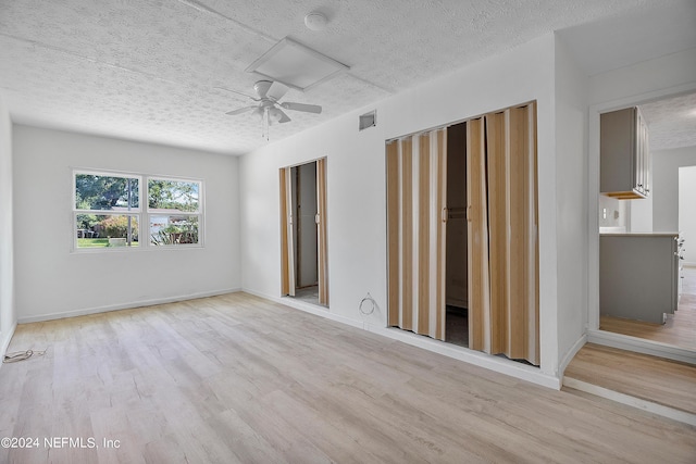 4435 Bedivere Rd, Jacksonville, FL 32208 - unfurnished bedroom with visible vents, a textured ceiling, baseboards, and wood finished floors
