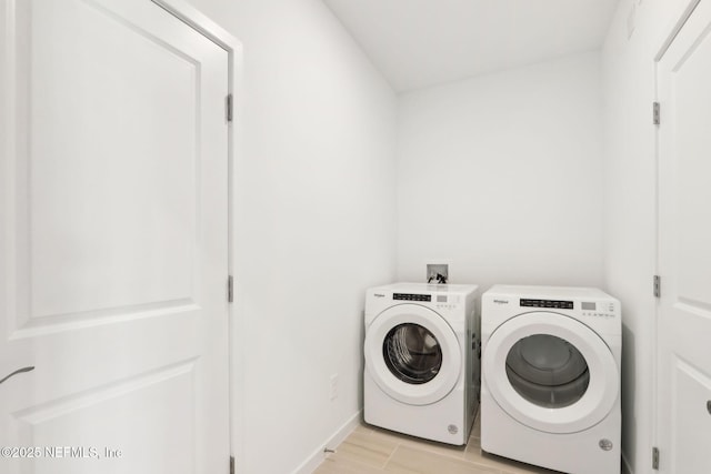 laundry area featuring laundry area, light wood-style floors, and washing machine and clothes dryer