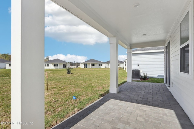 view of patio / terrace featuring a residential view and central AC