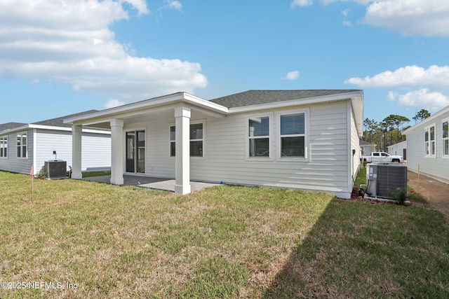 back of house with a patio area, a lawn, and central air condition unit