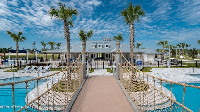 view of home's community with a water view and a swimming pool