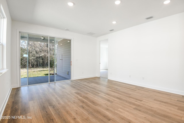 spare room featuring light wood-type flooring