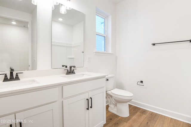 bathroom with vanity, hardwood / wood-style floors, and toilet