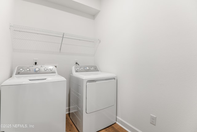 laundry area featuring separate washer and dryer and dark wood-type flooring