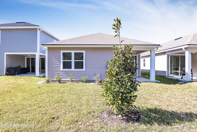 rear view of property with a lawn