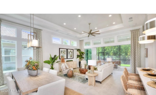 sunroom with a raised ceiling and ceiling fan