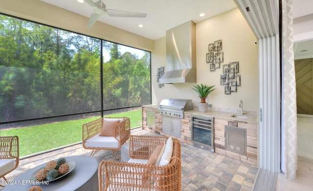 sunroom with wet bar, beverage cooler, and ceiling fan