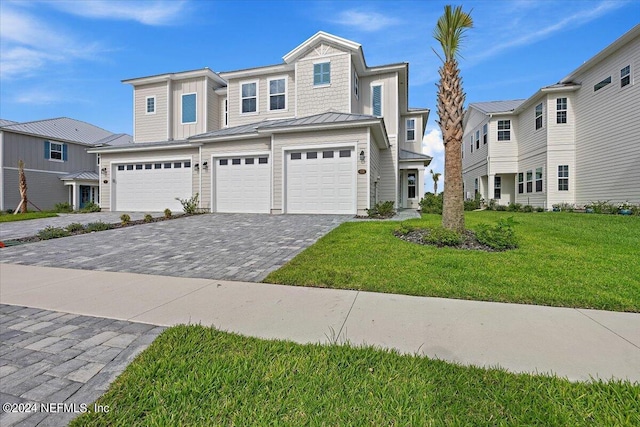 view of front of property with a garage and a front yard