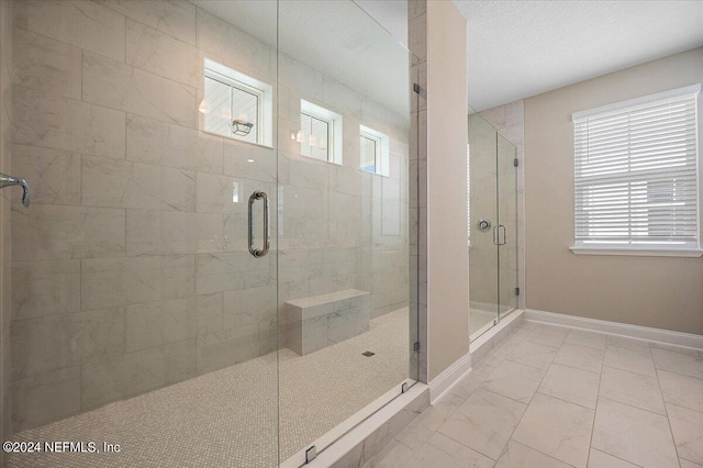 bathroom featuring a shower with shower door