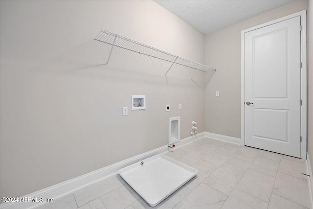 laundry room with gas dryer hookup, hookup for a washing machine, hookup for an electric dryer, and a textured ceiling