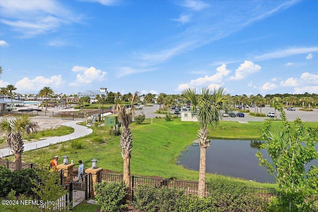 view of community featuring a water view and a yard