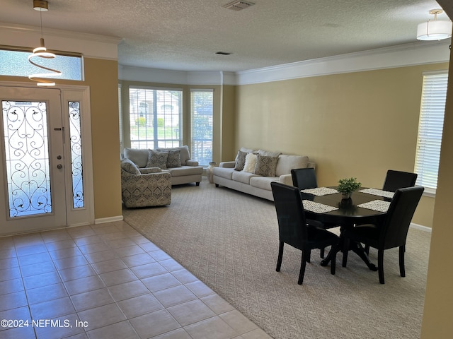 tiled dining area with baseboards, ornamental molding, and a textured ceiling