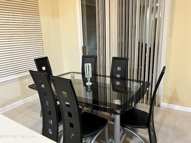 dining room featuring tile patterned flooring and baseboards